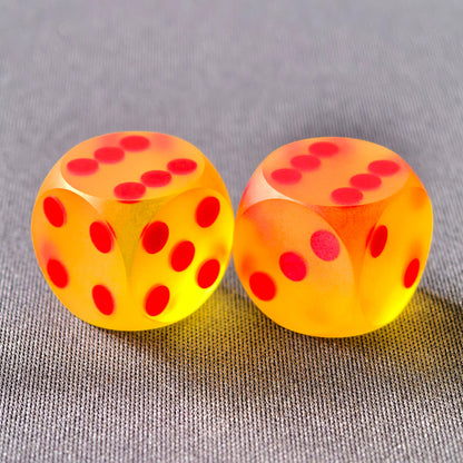 Non-glare translucent orange and yellow dice with red pips.
